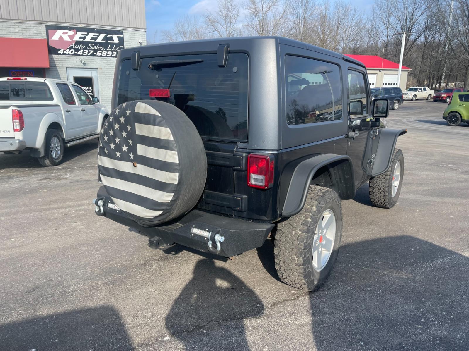 2013 Black /Black Jeep Wrangler Sport 4WD (1C4AJWAG0DL) with an 3.6L V6 DOHC 24V FFV engine, 6 Speed Manual transmission, located at 547 E. Main St., Orwell, OH, 44076, (440) 437-5893, 41.535435, -80.847855 - This 2013 Jeep Wrangler Sport 4WD, equipped with a robust 3.6L Pentastar V6 engine and a 6-speed manual transmission, represents a premium blend of performance and rugged capability. Its Trail Rated designation underscores a commitment to off-road excellence, featuring modifications such as LED head - Photo #8